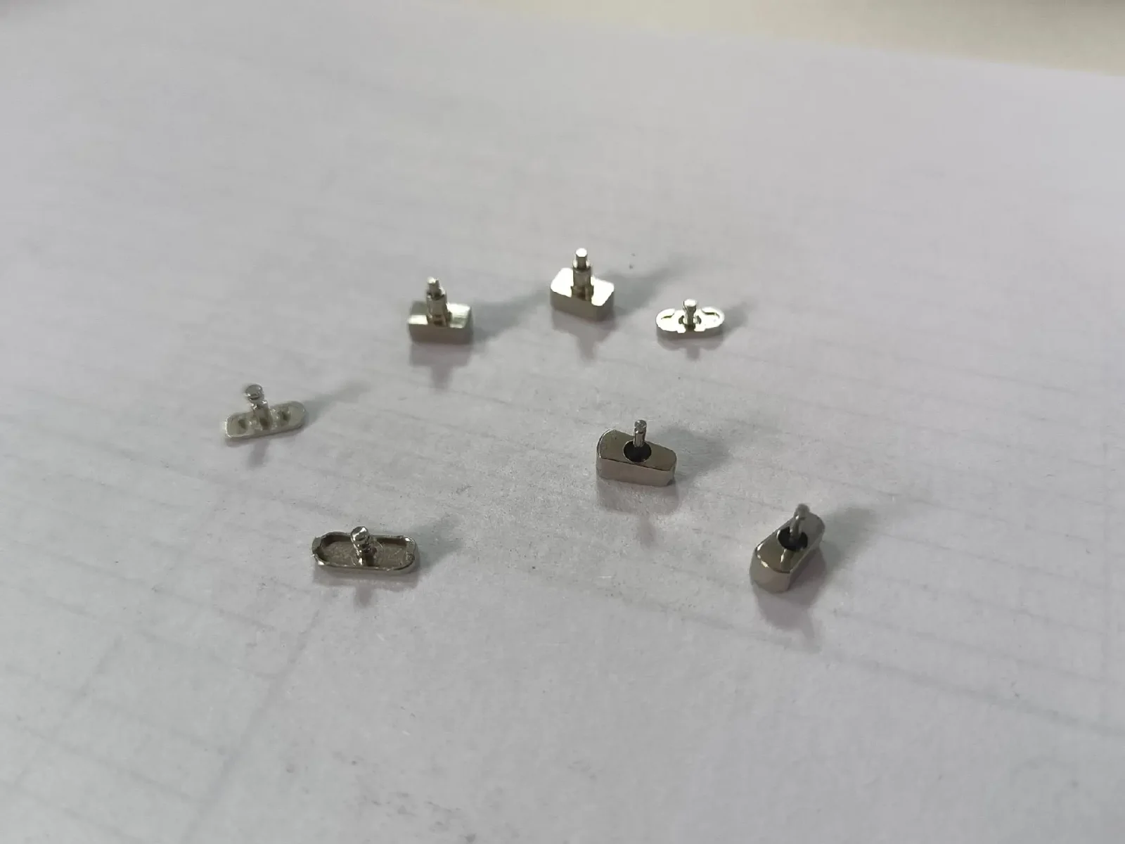 Swiss machined part with live-tool features