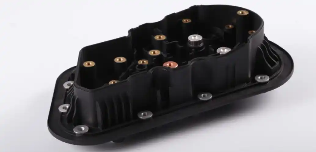Plastic insert molded component with metal inserts